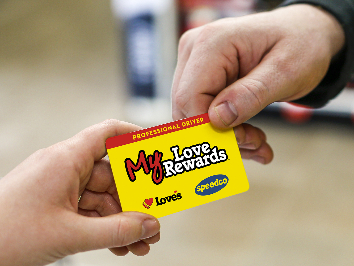 MLR card being handed from a customer to a cashier with a Love's Coffee cup