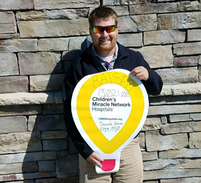 loves employee holding cmn balloon