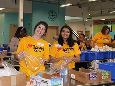 loves employees packing snacks at food bank