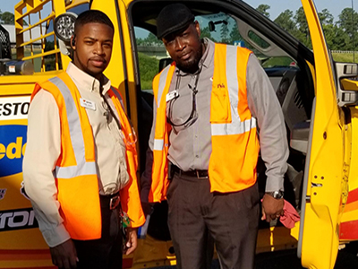 loves managers standing in next to service truck