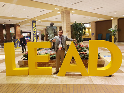 Tryston F. in front of a LEAD sign