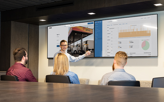 A photo of employees in a conference room looking at Shop Connect V.I.E.W.